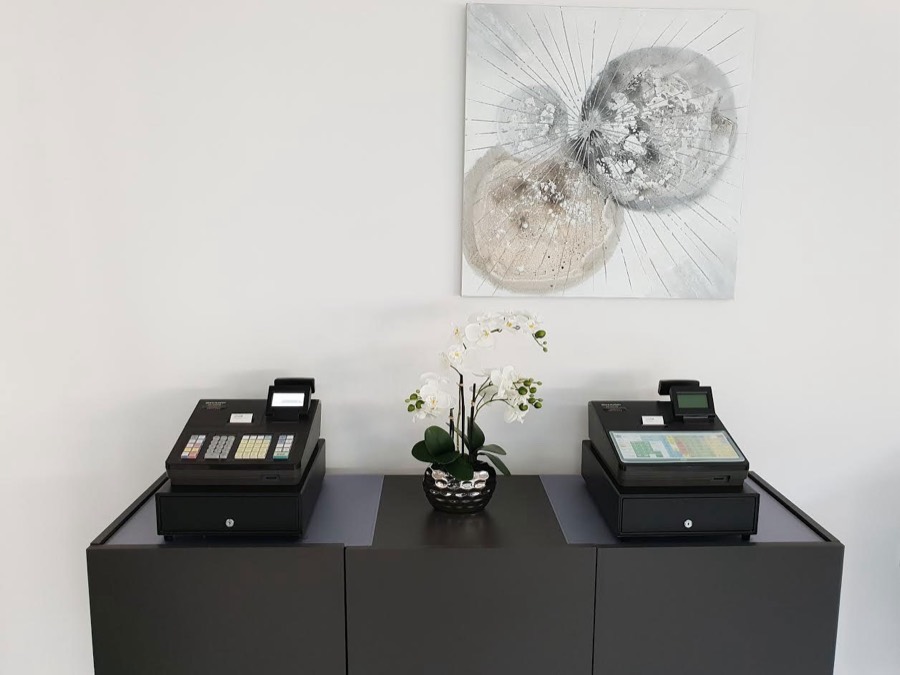 Zwei Registrierkassen auf einem Sideboard im Ausstellungsraum